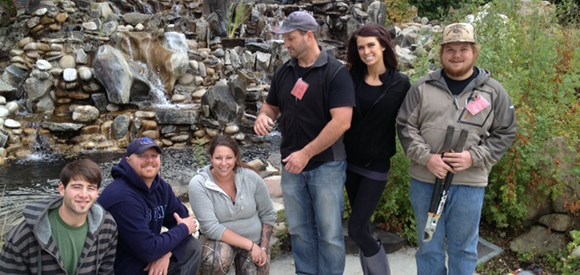 Group photo of six College of Western Idaho students in front of water feature.