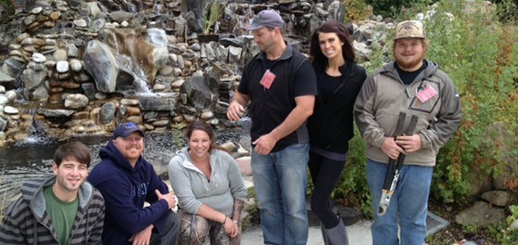 lt= Group photo of six College of Western Idaho students in front of water feature.