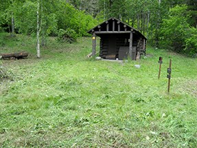 The same cabin as above after vegetation has been cleared--cabin in a clearing.