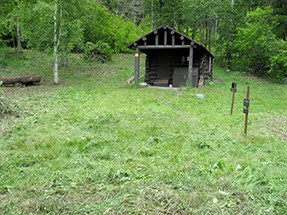 lt= The same cabin as above after vegetation has been cleared--cabin in a clearing.