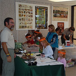 National Fossil Day Activity people visiting fossil touch table