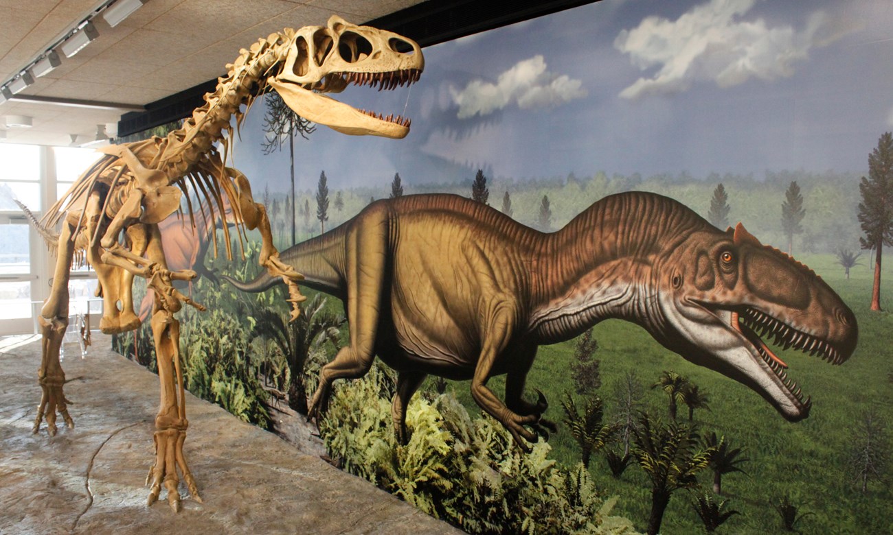dinosaur exhibit with skeleton and life mural