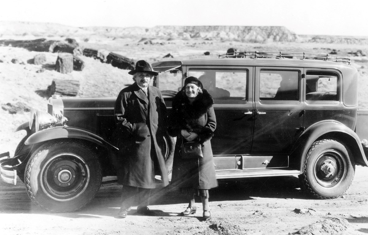 Albert Einstein and Elsa stand by car on visit to petrified forest area