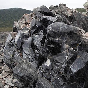 Photo of sharply broken volcanic glass boulder.