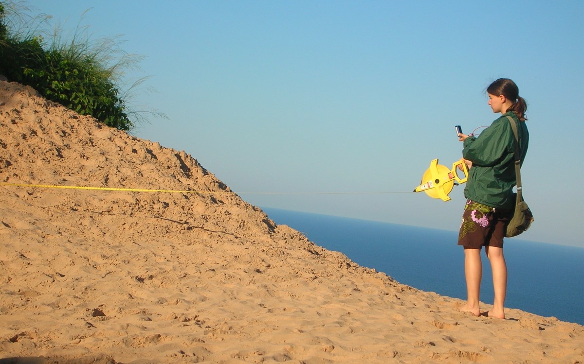 person surveying coastal dune