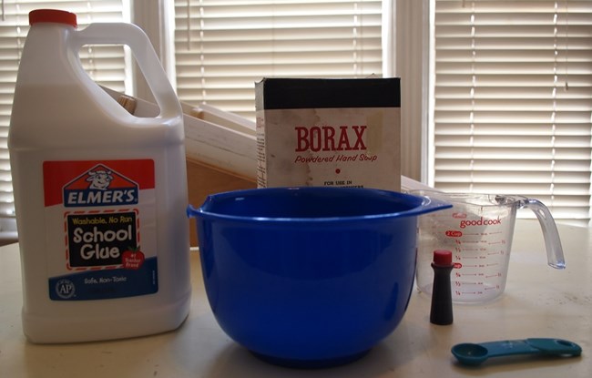 Glue, borax, water, food coloring, and utensils for making flubber