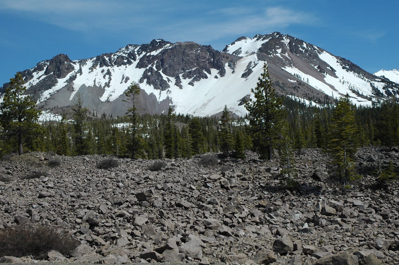 LAVO KLMN View of the Chaos Crags across from the rocky Chaos Jumbles with patches of snow on the slopes.