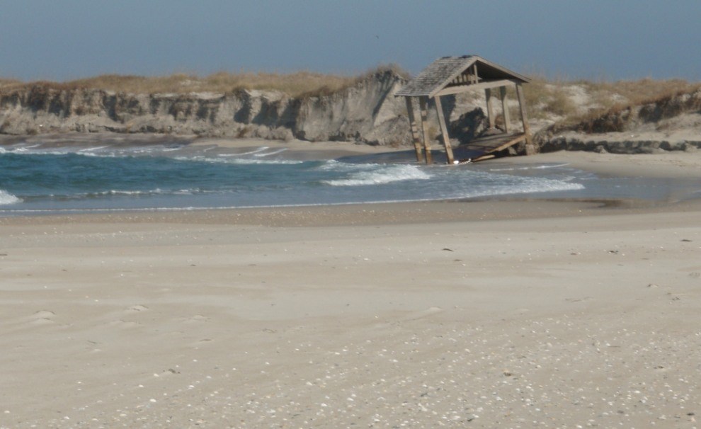 storm damaged shelter tipped in to waves