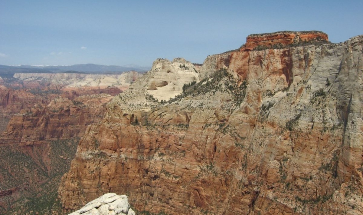 Photo of layered rock cliffs and canyon.