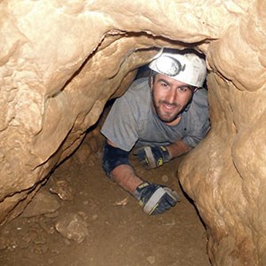 person crawling in cave