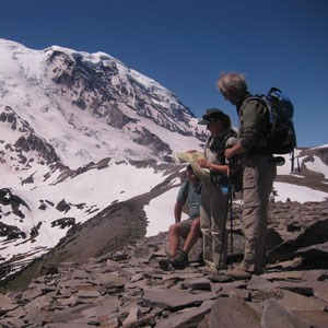 mentor 1 three people in front of snowy peak