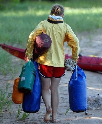 Kayaker packing up from a long day Girls carrying gear and packing up after kayaking