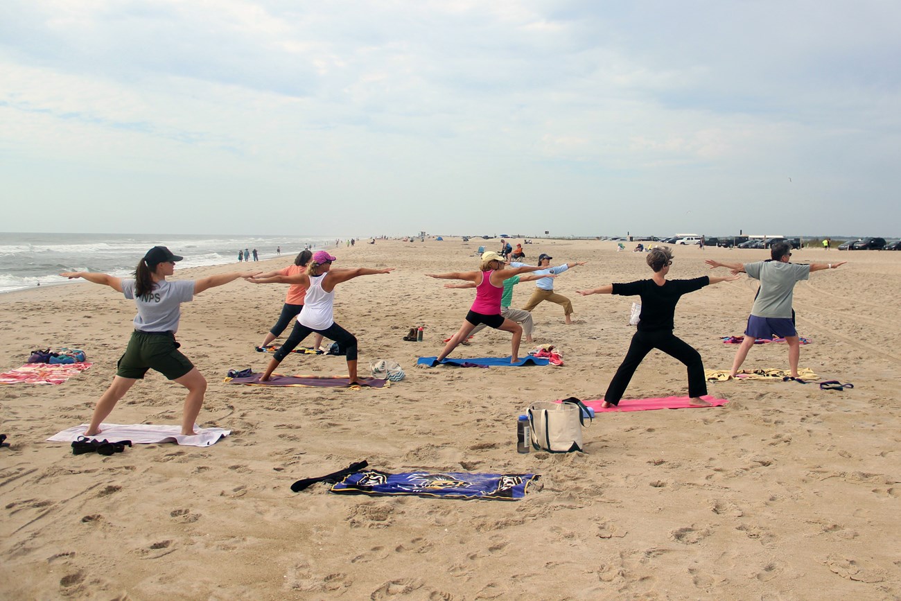 Visitors doing yoga at Assateague Island National Seashore