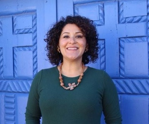 Learn more about Laura Flores. picture of woman posing for headshot