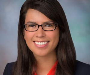 woman in glasses poses for picture