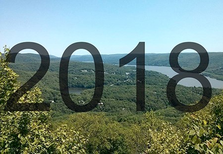 Text: "2018" over view of forested mountains and forest. Text: "2018" over view of forested mountains and forest.