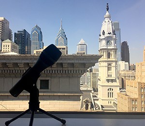 A microphone in front a view of buildings.