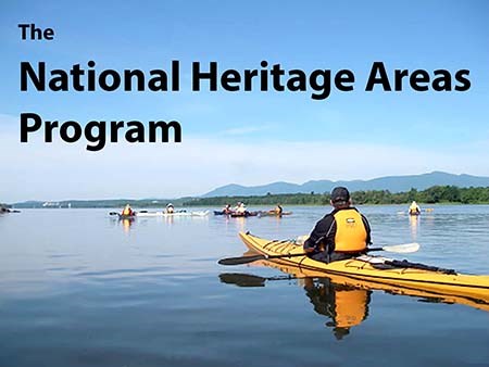 Text: "The National Heritage Areas Program" over people kayaking on a river.
