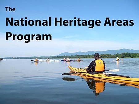 Text: "The National Heritage Areas Program" over people kayaking on a river. Text: "The National Heritage Areas Program" over people kayaking on a river.