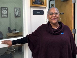Executive Director Shauntee Daniels of Baltimore NHA Smiling woman standing in front of an office