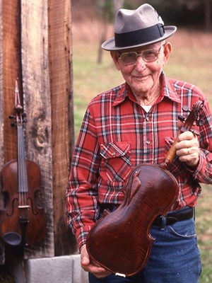 West Virginia musician Clyde Howes holds his fiddle
