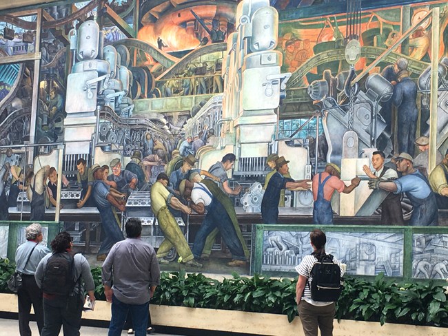 Visitors viewing Diego Rivera’s mural of industrial workers at the Detroit Institute of Arts during ANHA visit