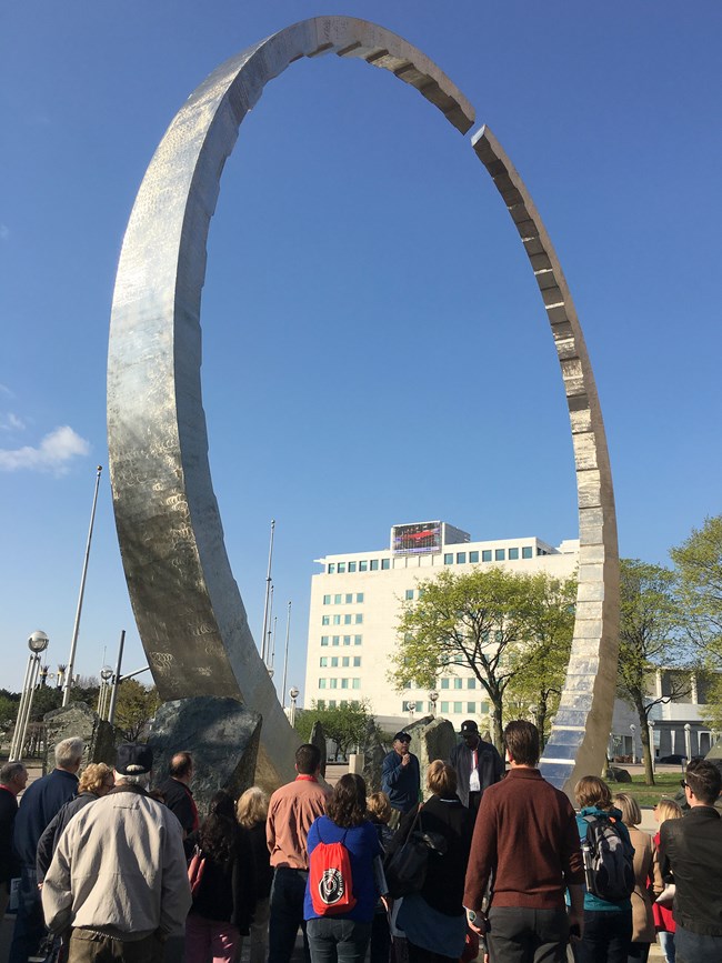 ANHA attendees next to Transcending circular sculpture on the Detroit Waterfront