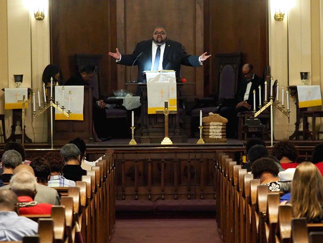 Reverend James A. Keeton speaking in front of audience at Morris Brown AME Church, Watch Night, 2018