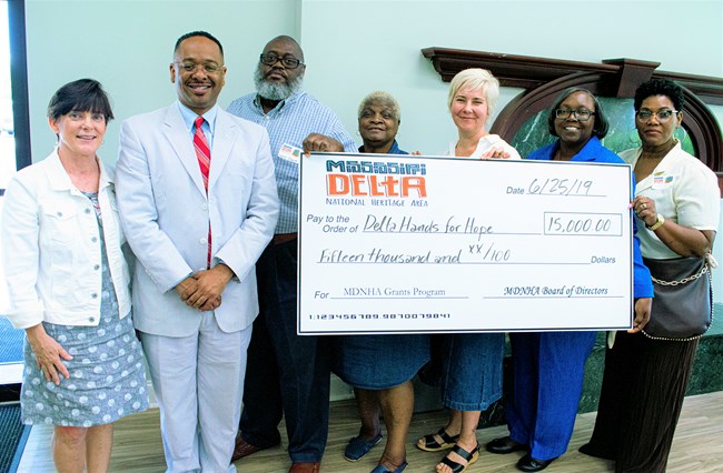 Mississippi Delta NHA representatives present Delta Hands for Hope staff with a giant check for $15,000
