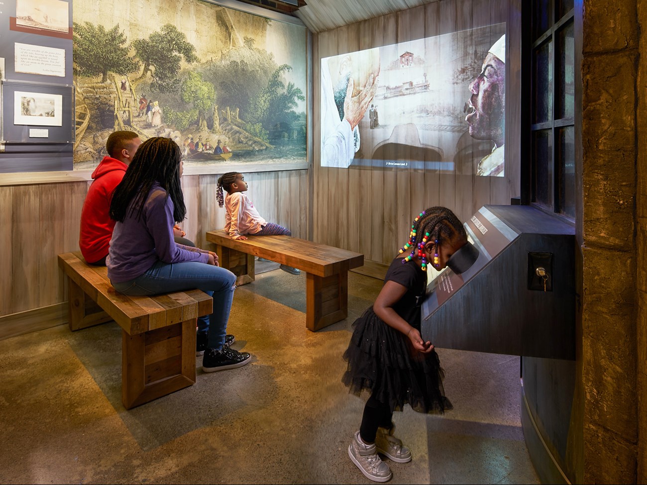 Visitors to the Niagara Falls Underground Railroad Heritage Center engage in interactive multimedia exhibits
