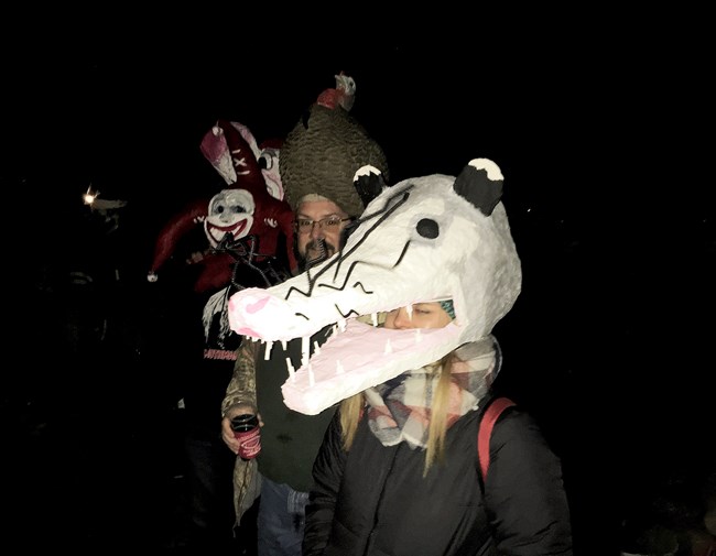 A girl in a oppossum mask.