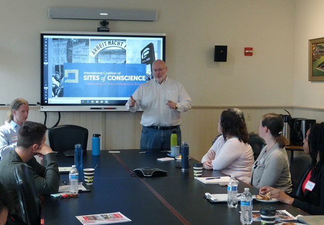 Rivers of Steel NHA President Augie Carlino speaks to NHA workshop attendees around a table