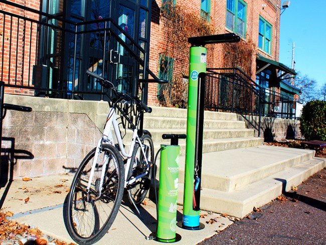 A bike is parked next to a bright green bike repair station at the Schuylkill River Greenway’s office in Pottstown, along the Schuylkill River Trail.