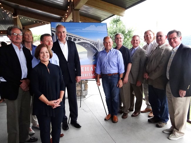 Group of eleven officials with Susquehanna NHA sign at Columbia Crossing