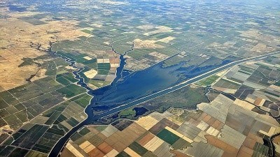 A river and canal cut through squares of farm land in Sacramento