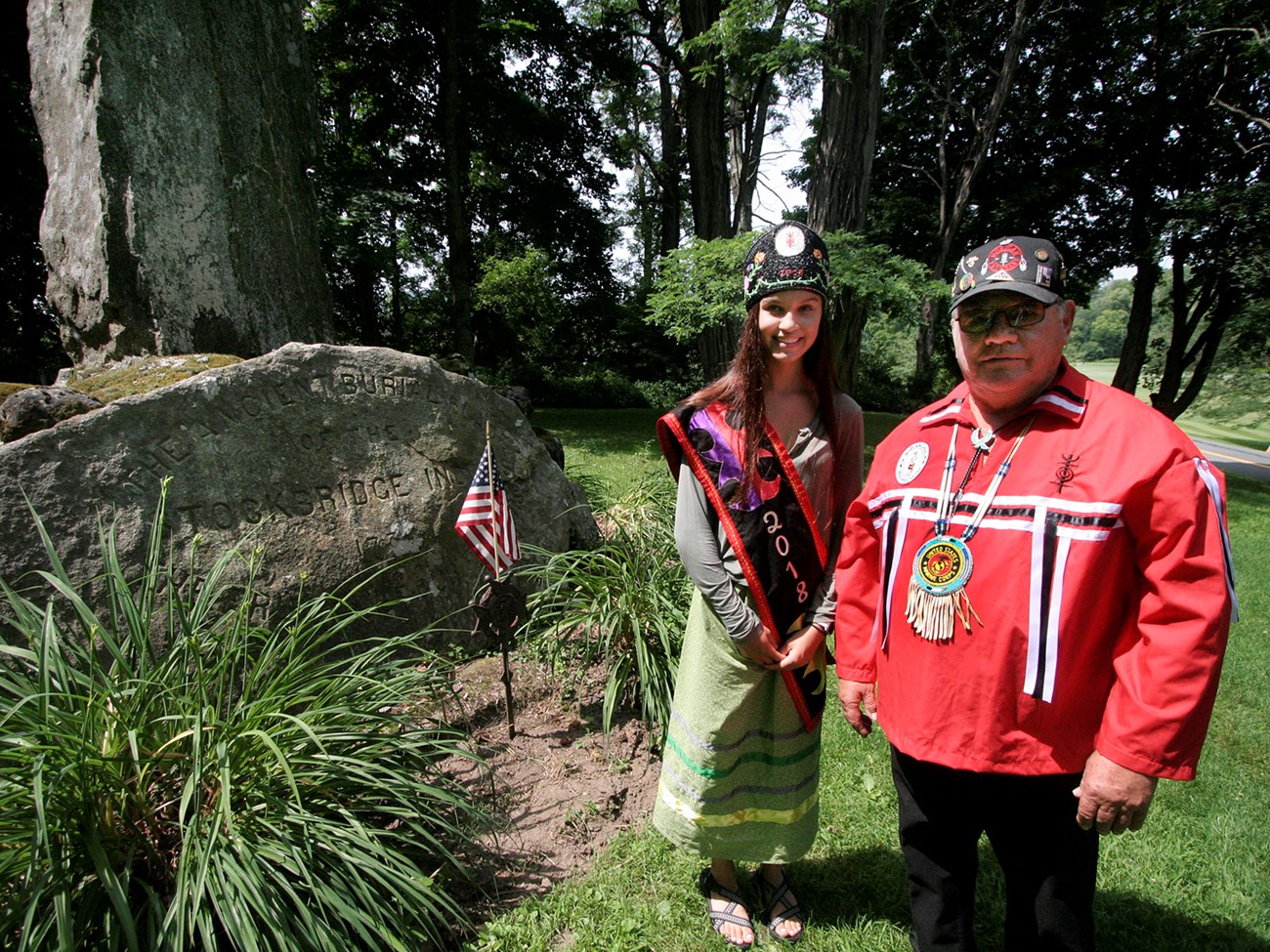 Stockbridge Indian Burial Ground Odessa Arce and Robert Little stand next to the stone pillar monument at the Stockbridge Indian Burial Ground