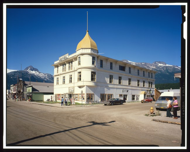 White hotel building with small gold dome