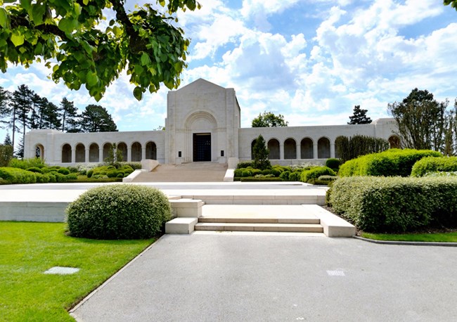 Photograph of white chapel building with topiary