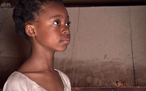 AFBG thumb A young black girl wearing a white dress faces right
