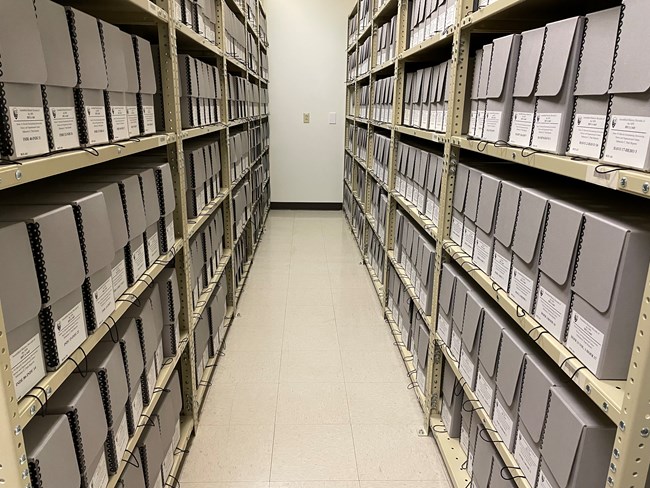 gray labeled boxes on shelving units