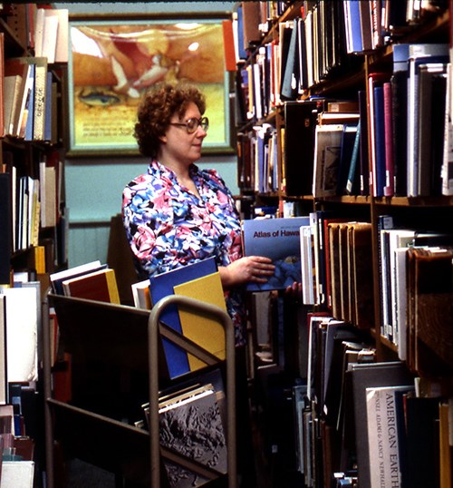 Nancy Potts Flannagan returning books to shelves at the Harpers Ferry Center Library.