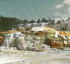 NPS Historic Photograph Collection Cleopatra Terrace, Mammoth Hot Springs at Yellowstone National Park, 1890s. Colored lantern slide by Henry G. Peabody.