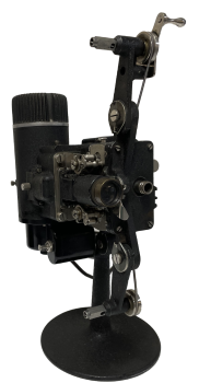 Black old time film projector on a pedestal base