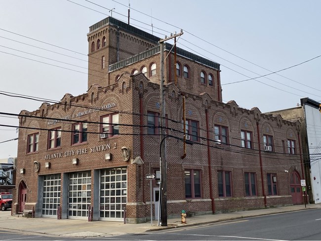 Brick building, a fire station, with blue sky.