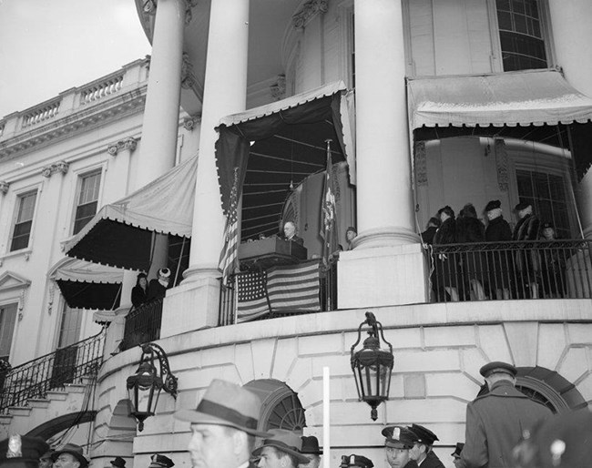 Franklin Delano Roosevelt stands at a high balcony giving an inaugural address