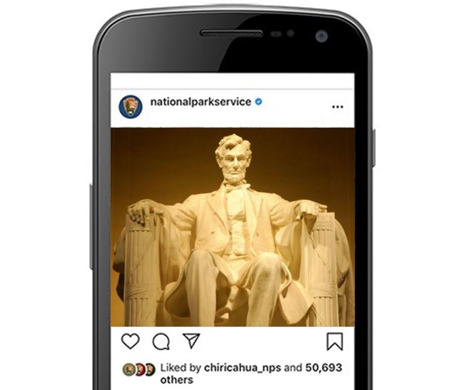 Cell phone with a screenshot of an Instagram post featuring a Abraham Lincoln statue