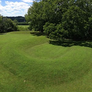 A grass covered mound within Serpent Mound State Memorial.