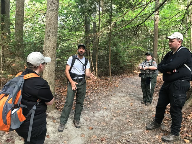 Icelandic park rangers visit New River Gorge. Icelandic rangers (far left and right) listen to an NPS ranger talk about trail management.