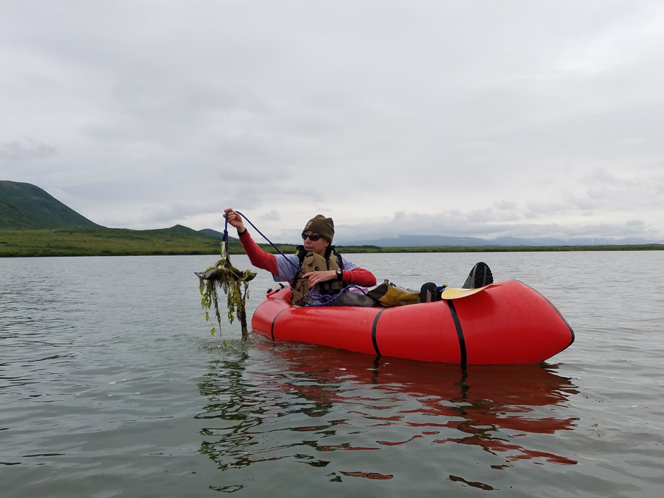 KATM_Contact_ Lake A member of the Alaska Exotic Plant Management Team (EPMT) surveys for Elodea spp. in Katmai National Park and Preserve.