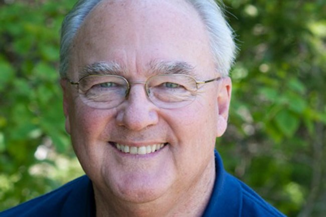 Man in blue shirt and glasses.